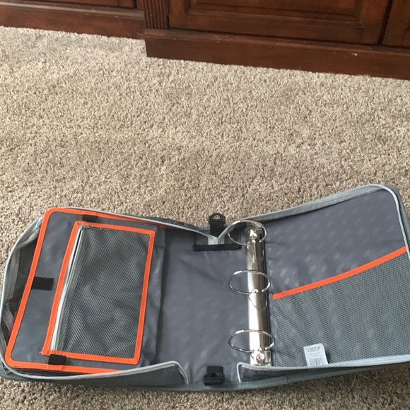 This is a case it binder perfect for holding papers that is orange and gray - Picture 2 of 4